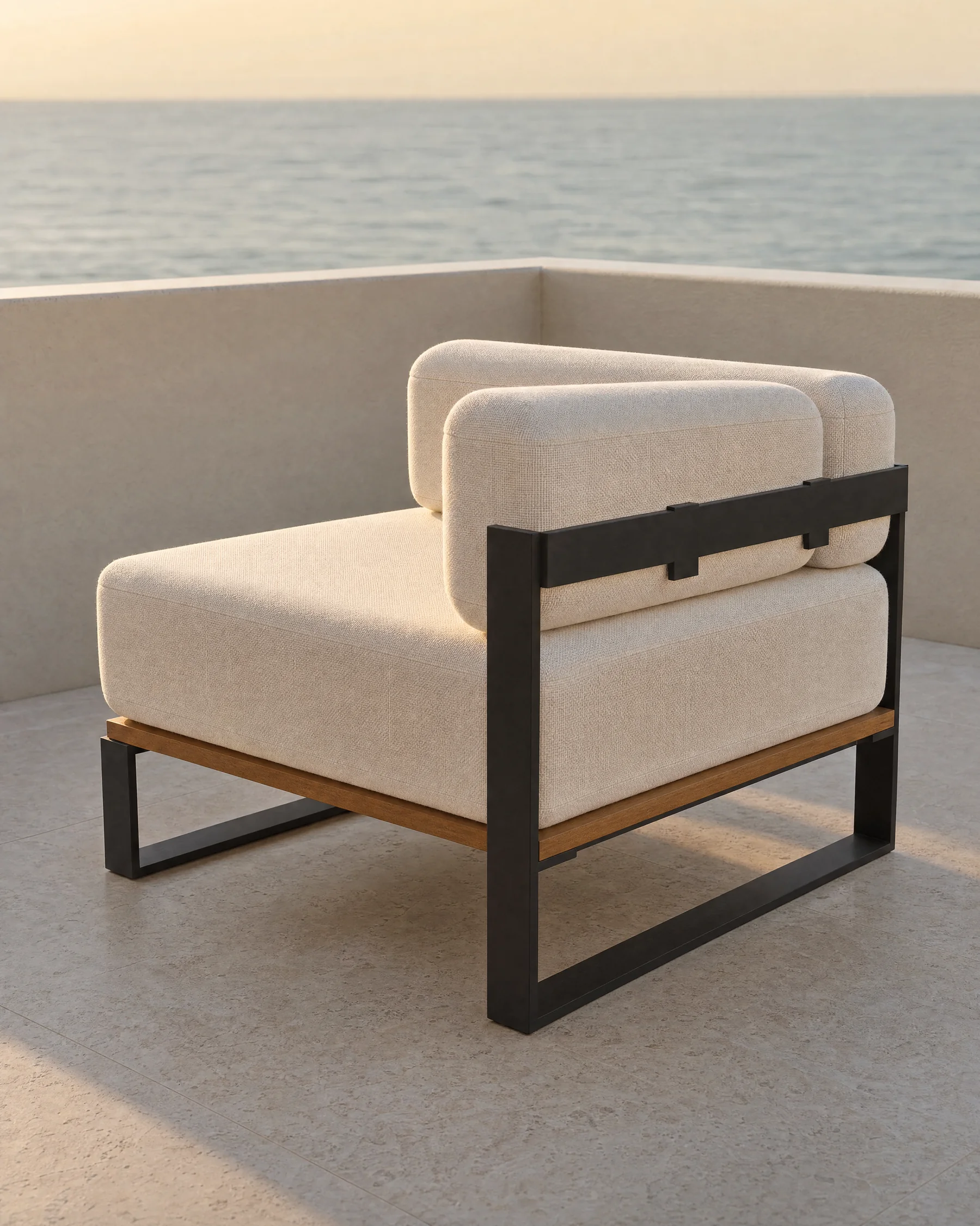 The Nour corner module alone at the corner of a roof terrace: an 800 millimetre square seat with two back bolsters meeting at a corner and the other two sides open, with the sea beyond the parapet.