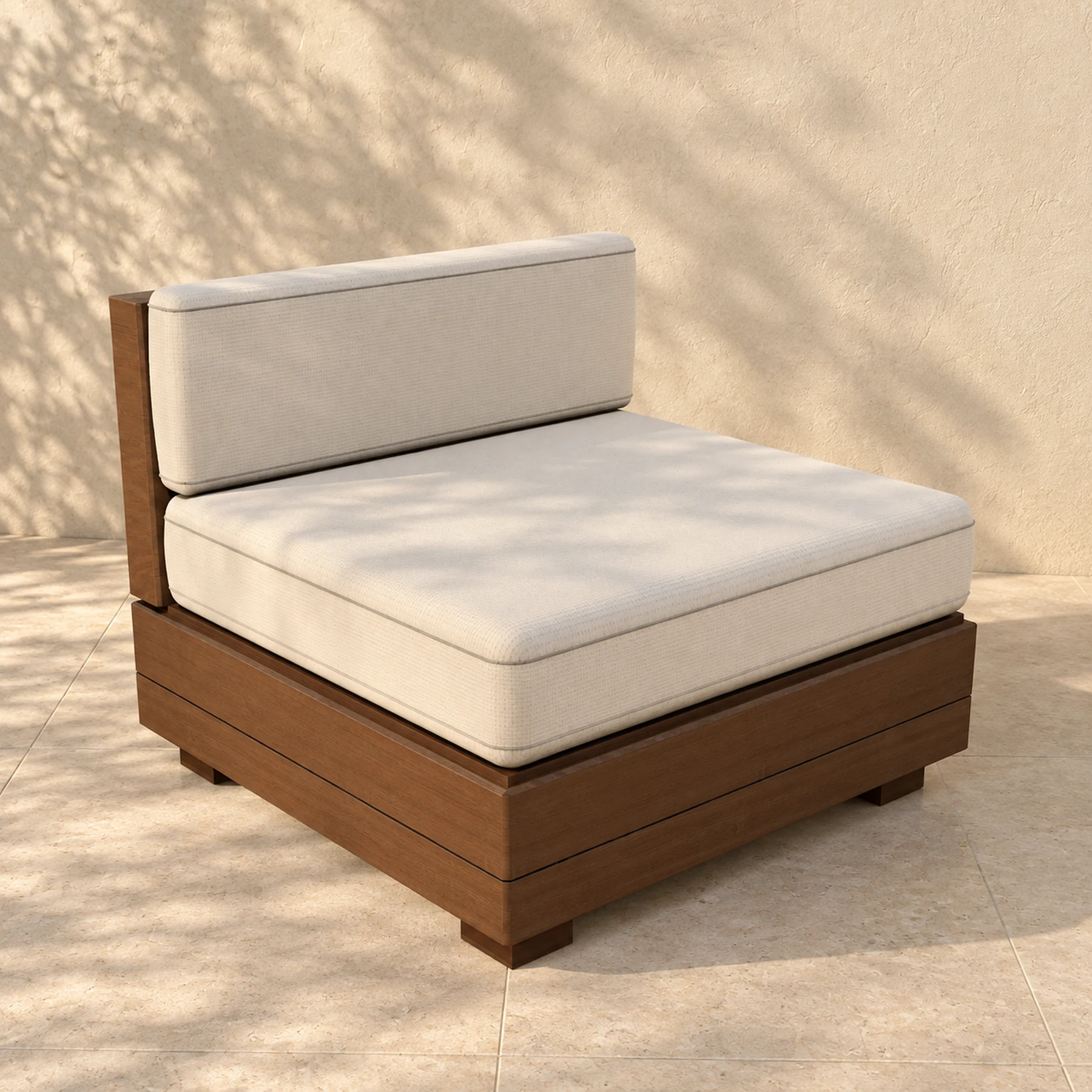 The Sama centre module alone on pale limestone paving before a warm plaster wall, the shadow of an olive tree across it: an 800 millimetre square seat on a closed timber plinth, with one timber back board and a boxed back cushion standing against it.